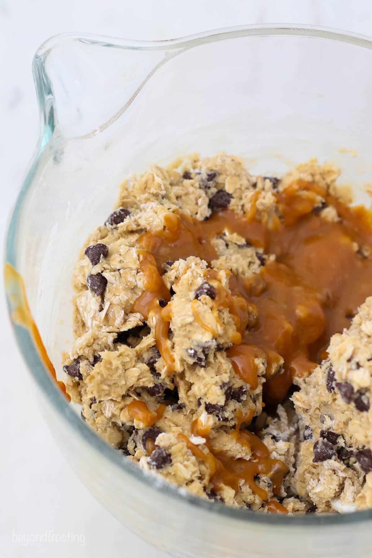 a bowl full of oatmeal cookie dough drizzled with caramel