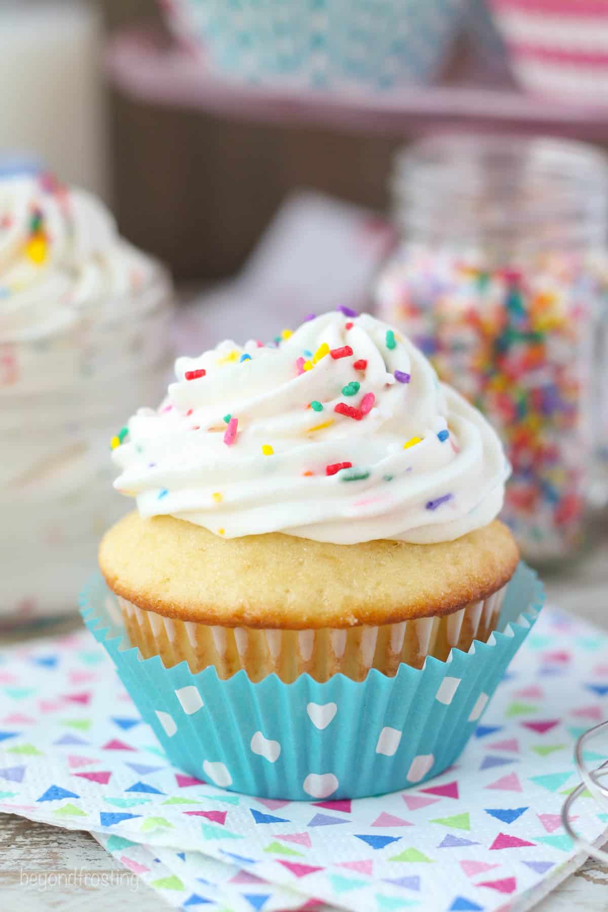 A cupcake topped with cake batter whipped cream