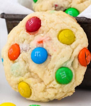 closeup of an M&M cookie leaning on a pan