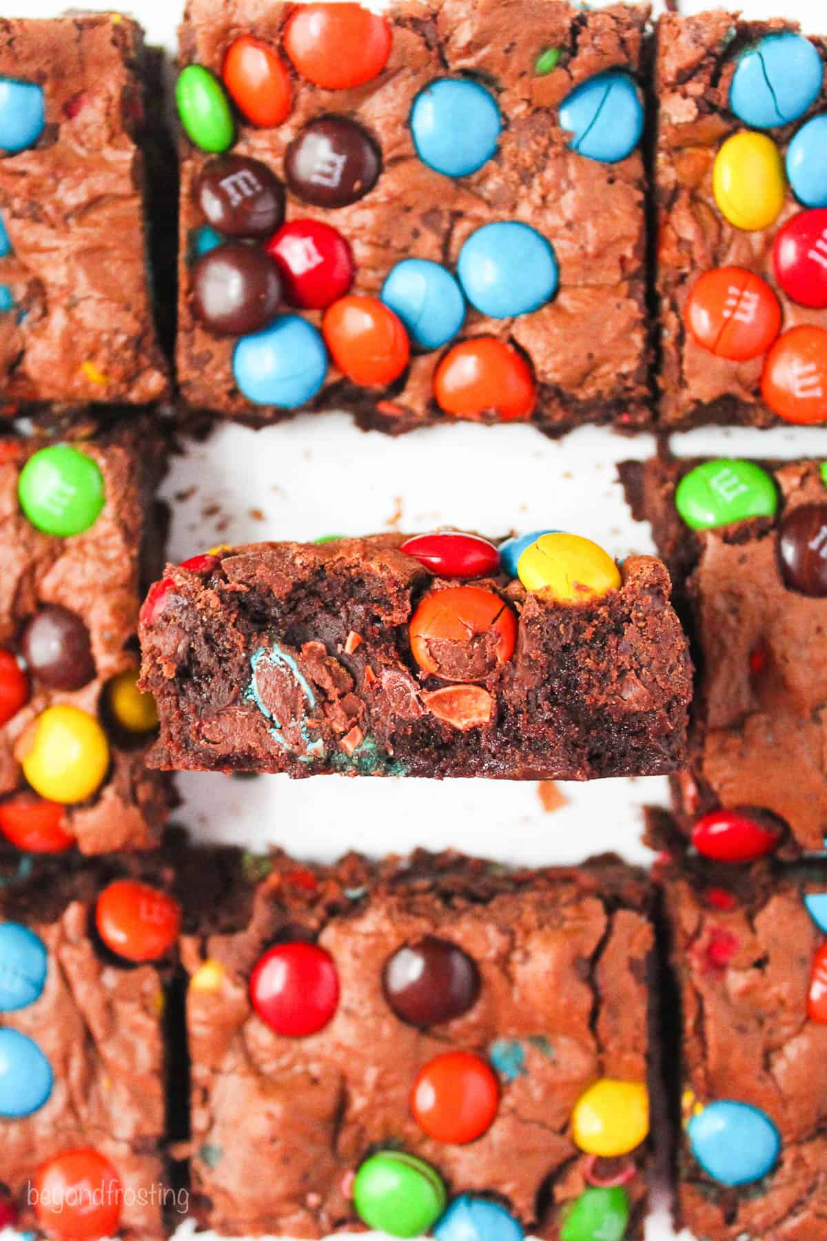 overhead of sliced brownies, one brownie balanced on its side