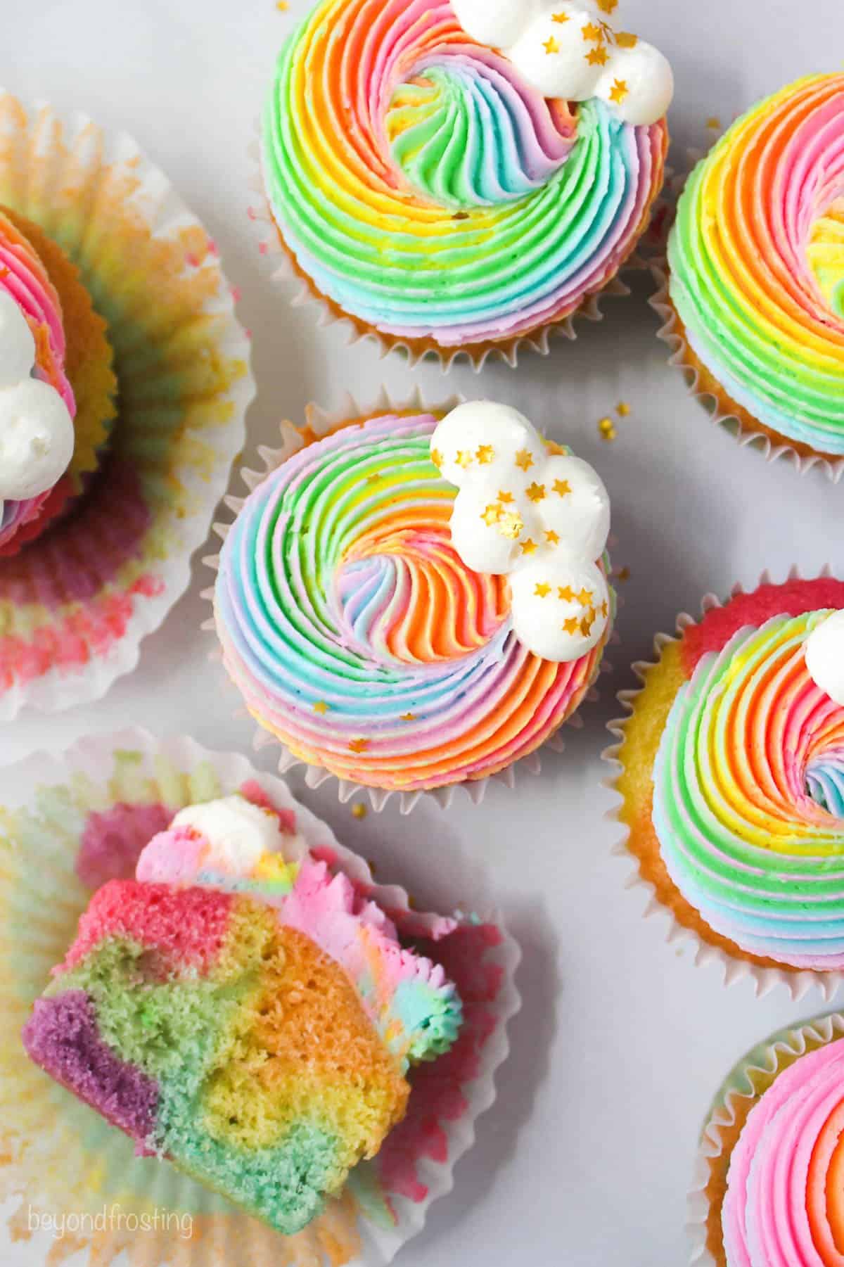 Overhead view of rainbow cupcakes with rainbow frosting