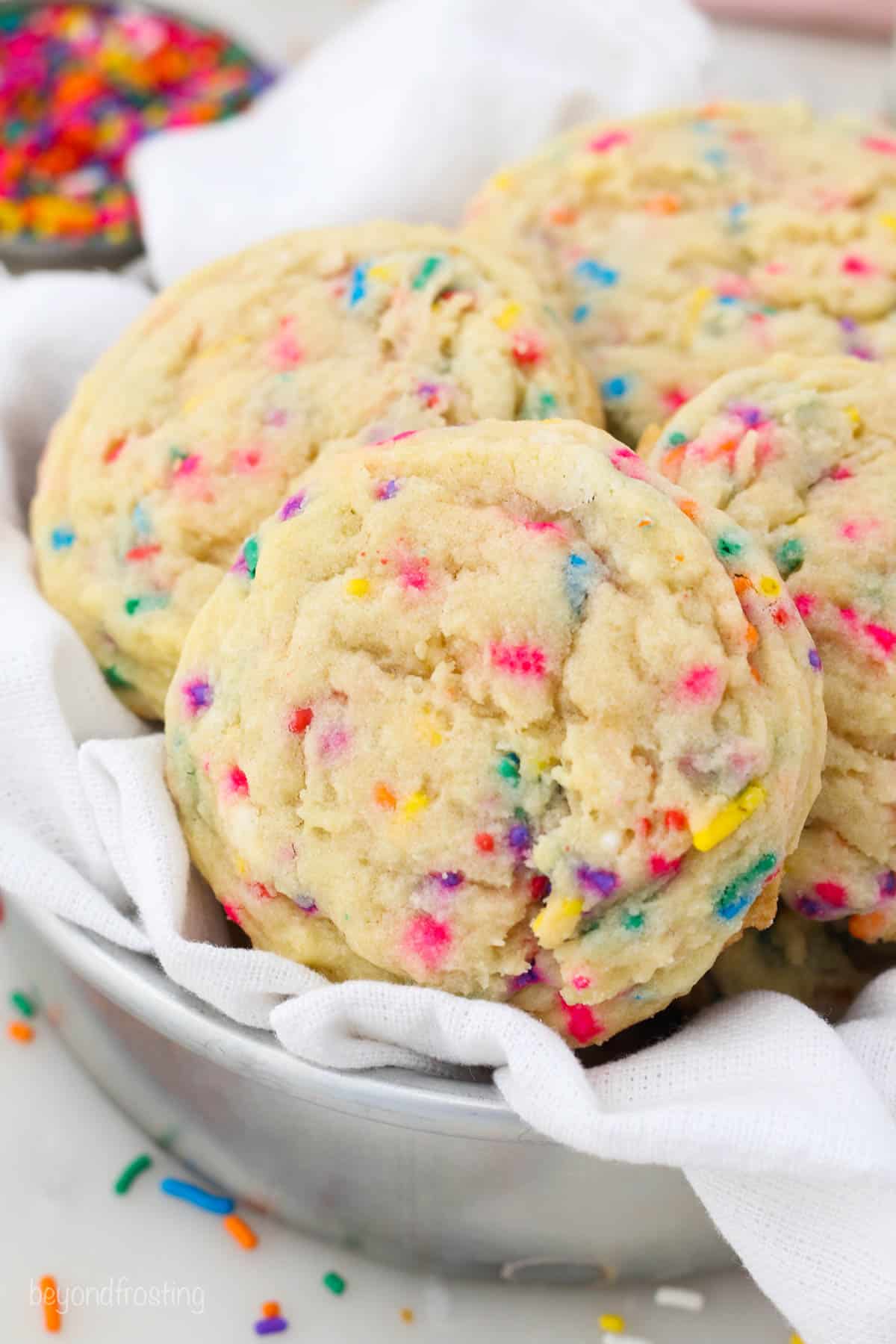 overhead of a tray full of sugar cookies with sprinkles