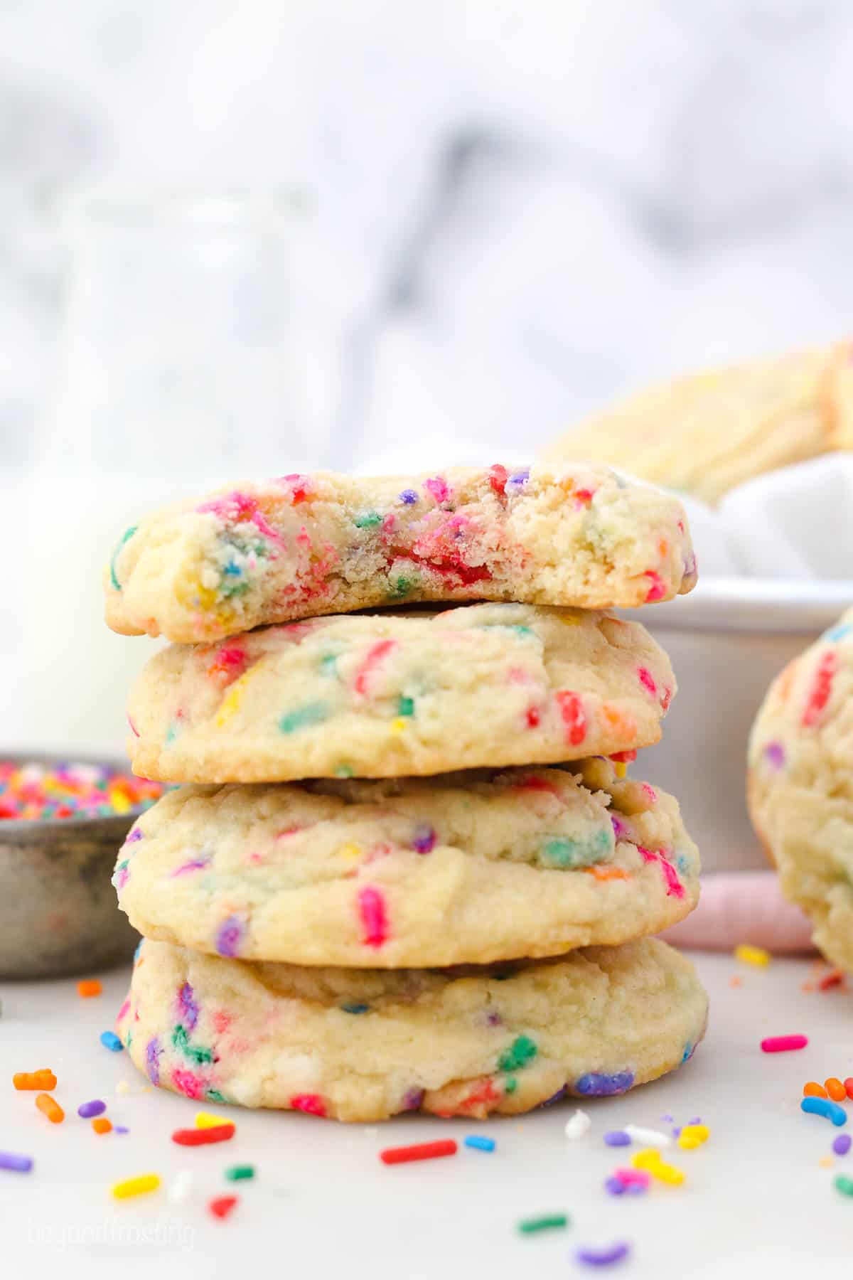 side view of four sprinkle cookies stacked