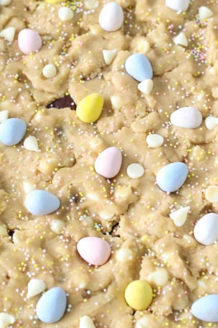 Cadbury Mini Eggs placed on top of cookie dougg