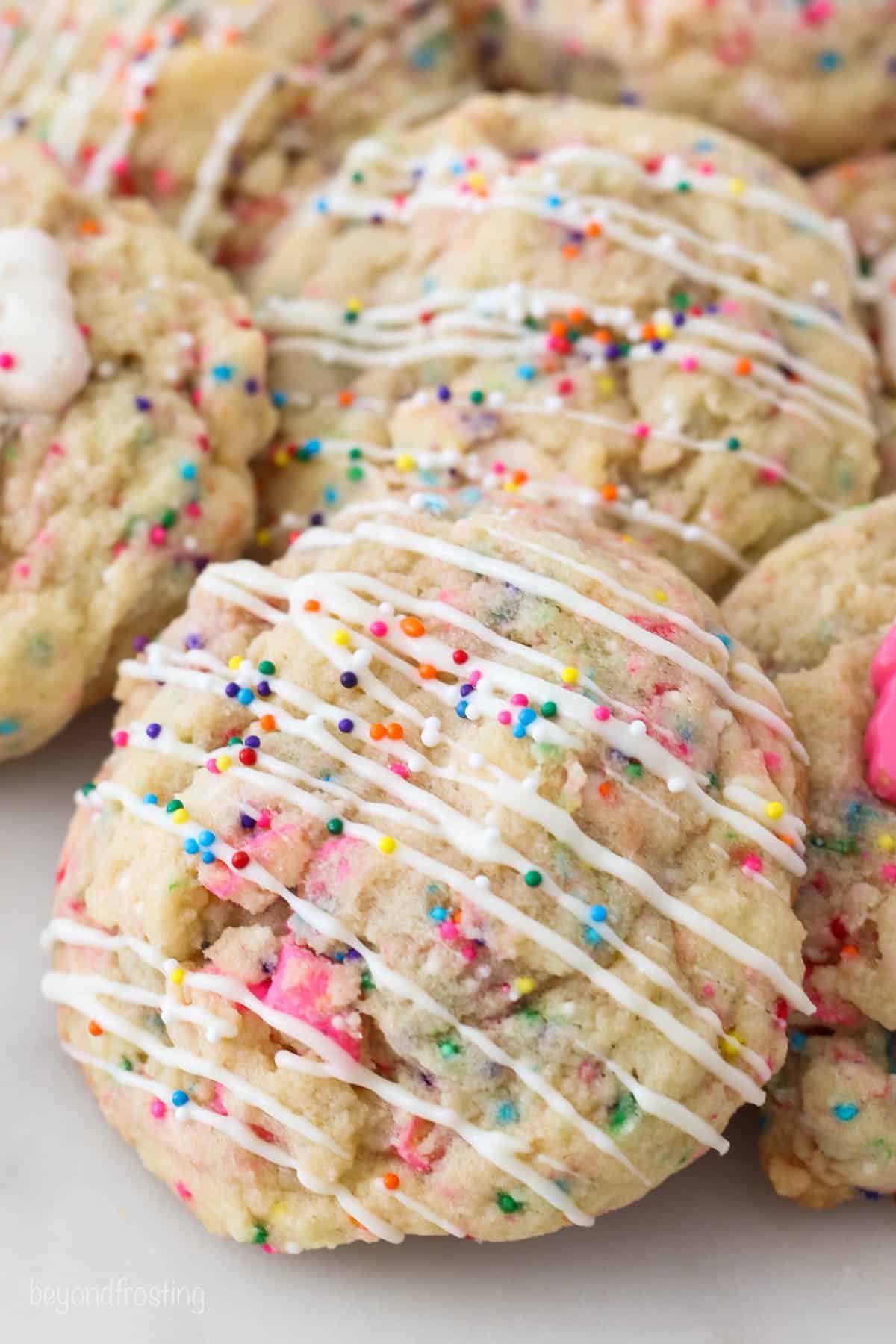 A tray of Circus Animal Stuffed Cookies with white chocolate and sprinkles on top