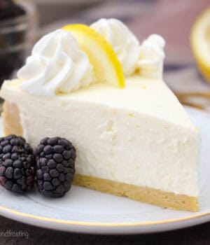 closeup of a slice of no-bake lemon cheesecake on a gold-rimmed white plate