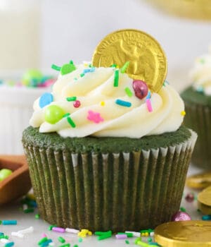 A green cupcake decorated for St. Patrick's Day