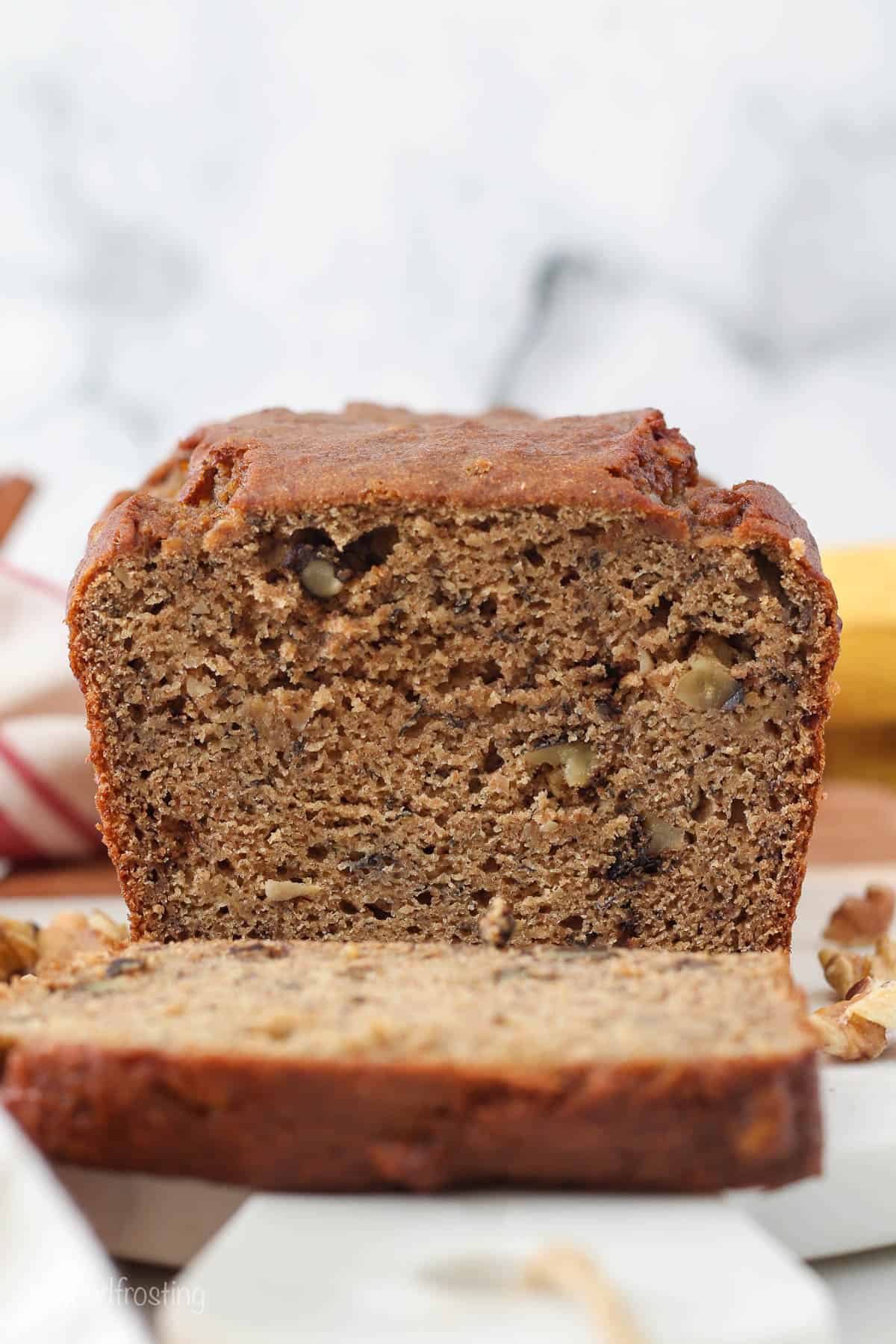 A loaf of healthy banana bread with one slice cut off