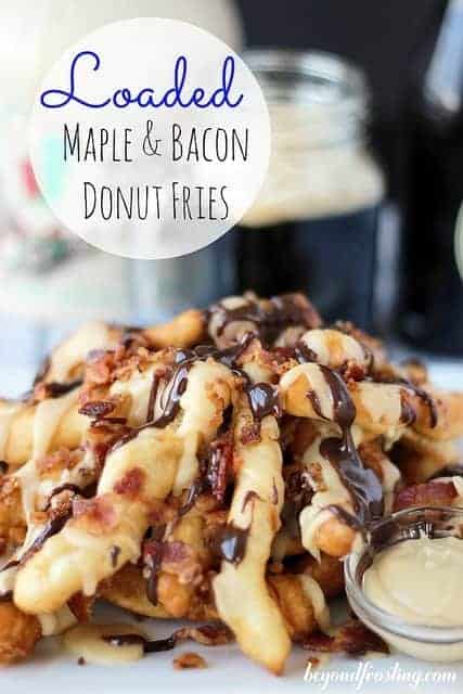 A plate of loaded doughnut fries beside a small dish containing homemade maple glaze