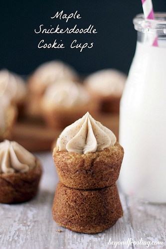 Two maple snickerdoodle cookie cups stacked on top of each other with a glass of milk beside them
