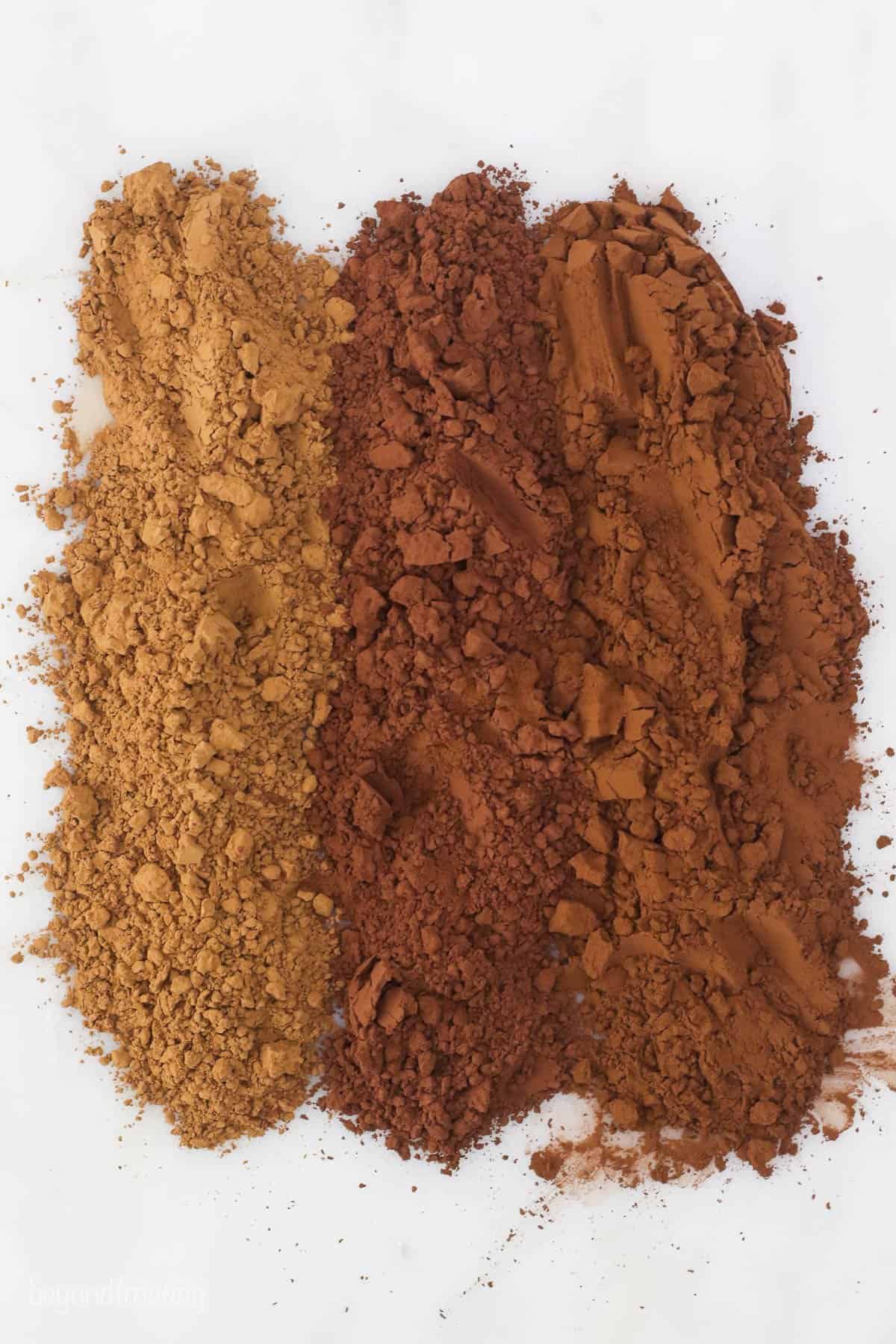 3 types of cocoa powder laid out on the table