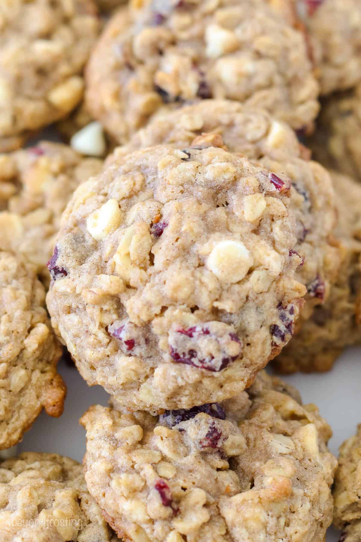 Overhead view of an oatmeal cranberry cookie on top of other cookies