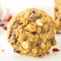 A white chocolate cranberry oatmeal cookie on its side