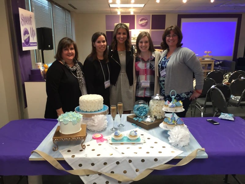 Author with a group of ladies behind a dessert table