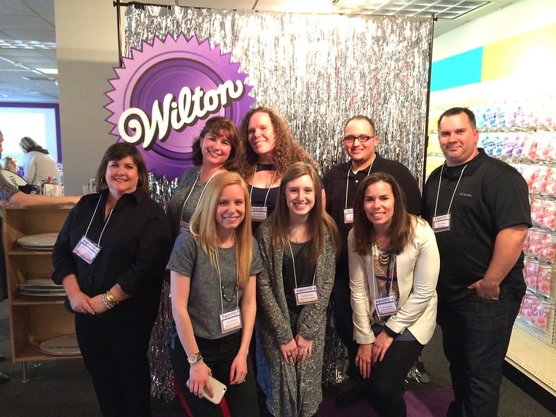 Author with a group of men and womens in front of a Wilton sign