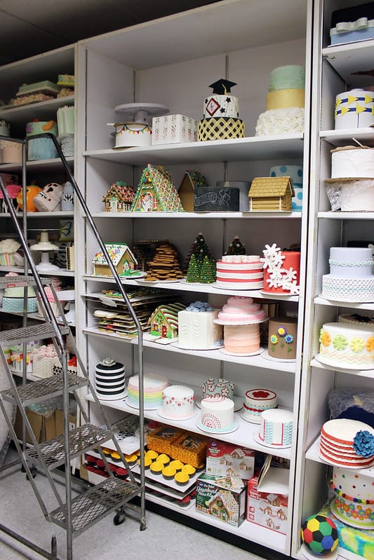 A wall of fake cakes on shelves inside the WIlton prop room
