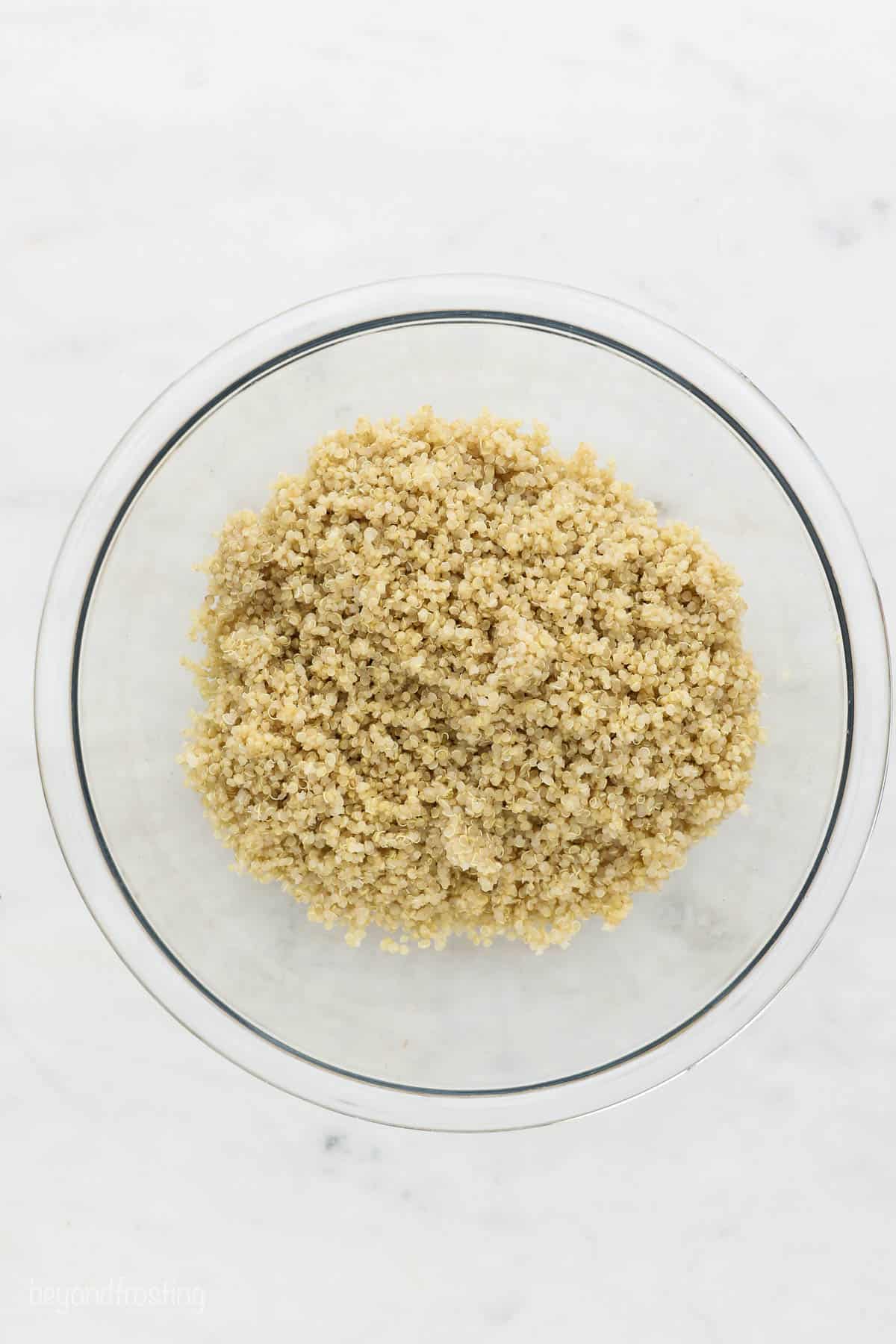 a clear glass bowl of cooked quinoa