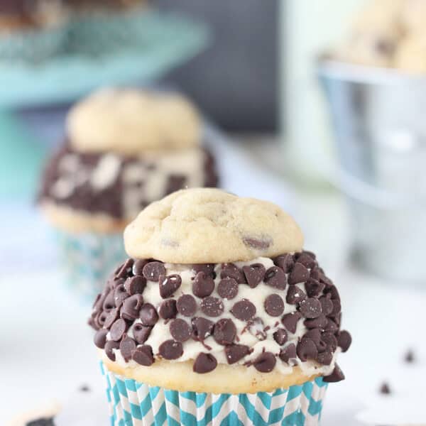 A cookie dough cupcake in a white and blue cupcake liner.
