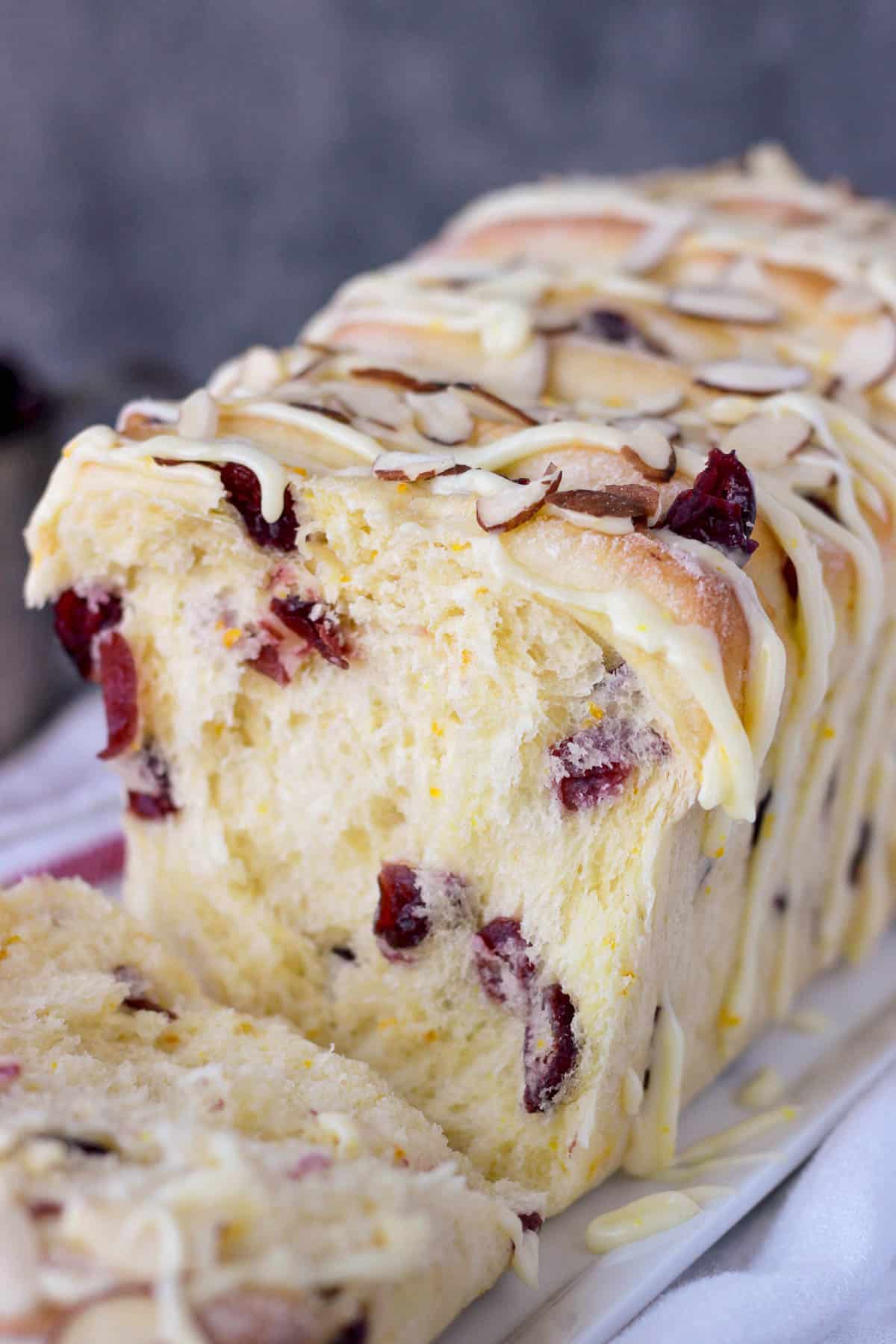 close up of the inside of a sweet bread loaf with cranberry and orange zest