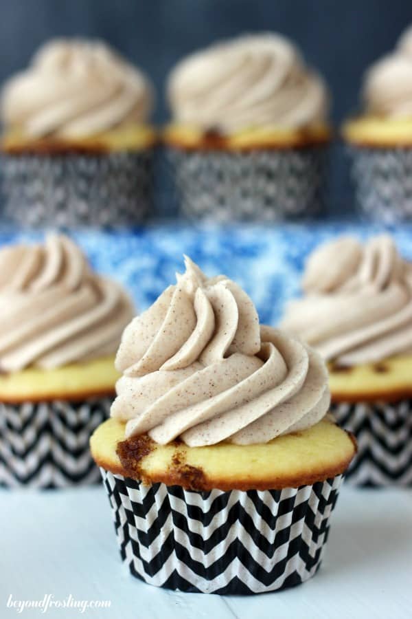 two rows of cinnamon roll cupcakes with one in the front