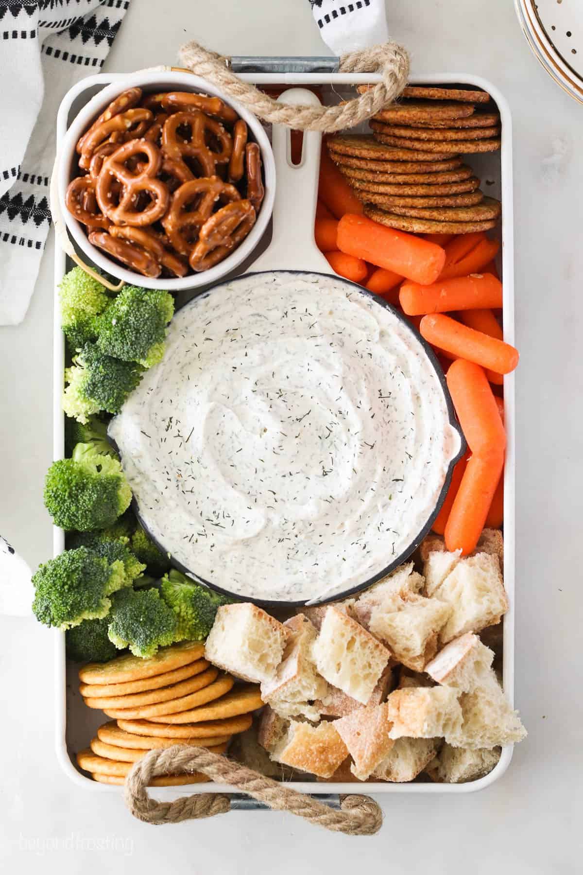 Overhead view of a veggie tray with dill dip in the center