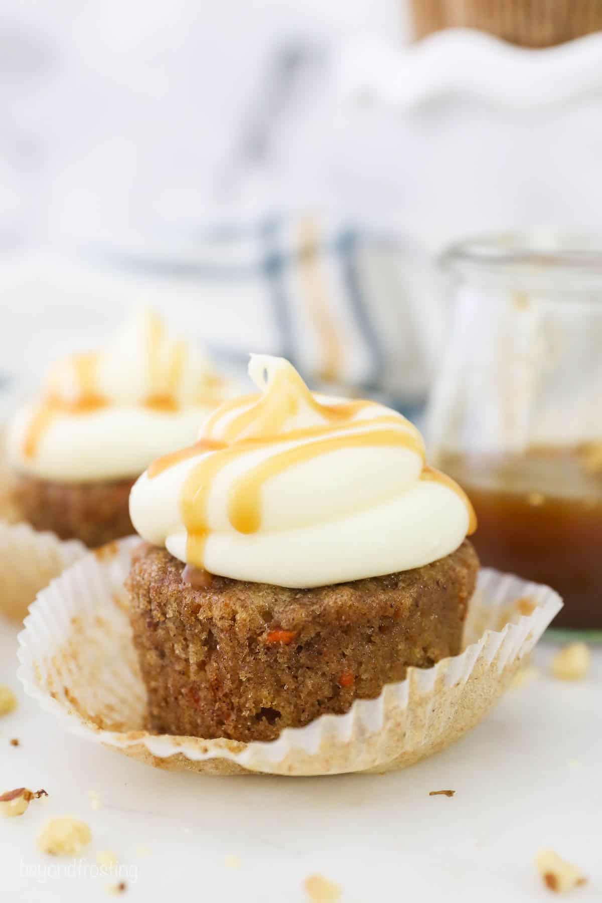A carrot cake cupcake with the cupcake liner pulled down