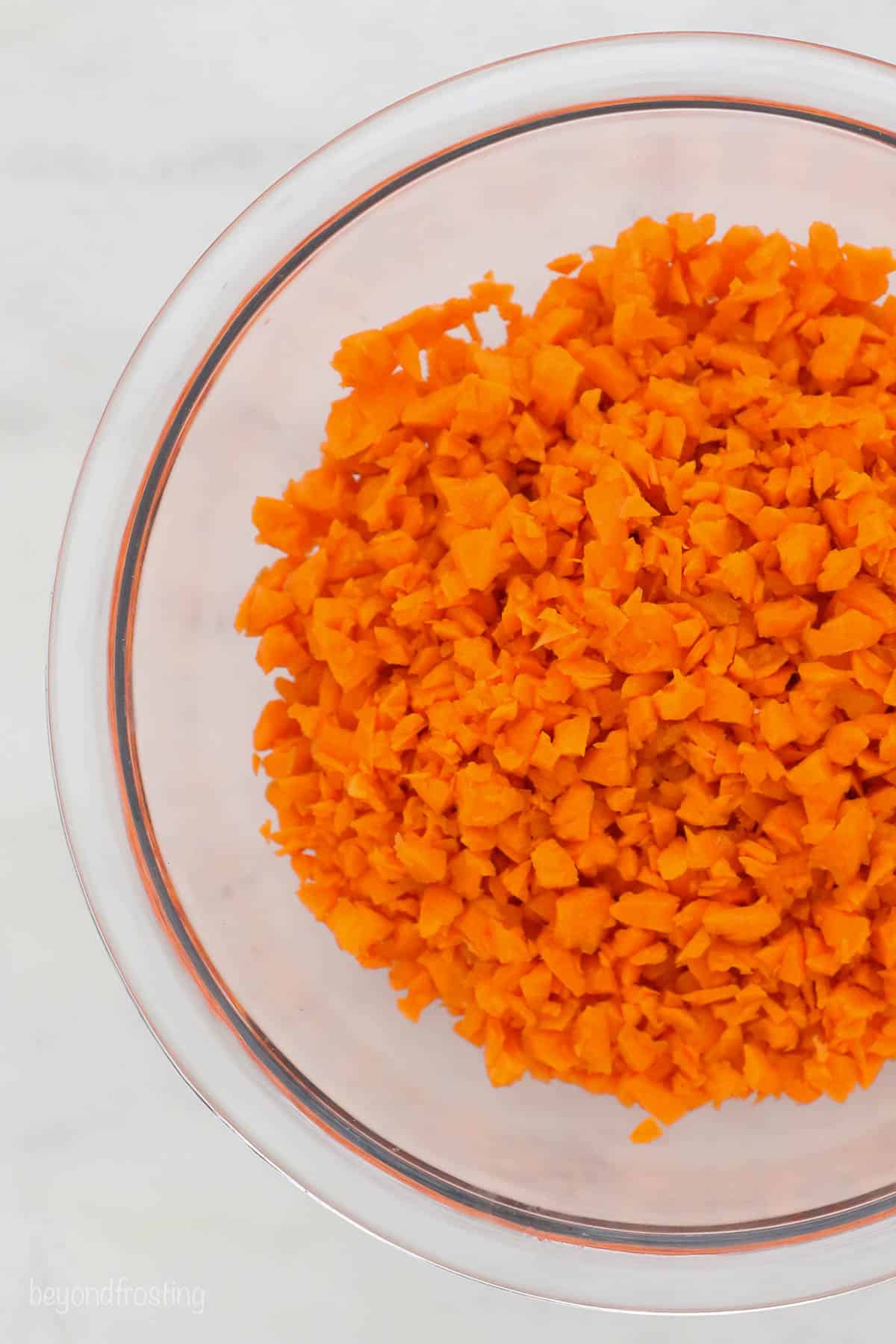 Shredded carrots in a glass bowl