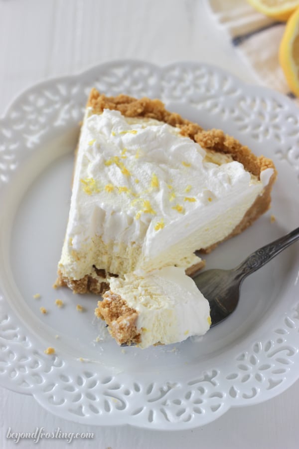 slice of lemon ice cream pie with a bite taken out