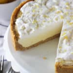 lemon ice cream pie on a cake stand with a slice cut out