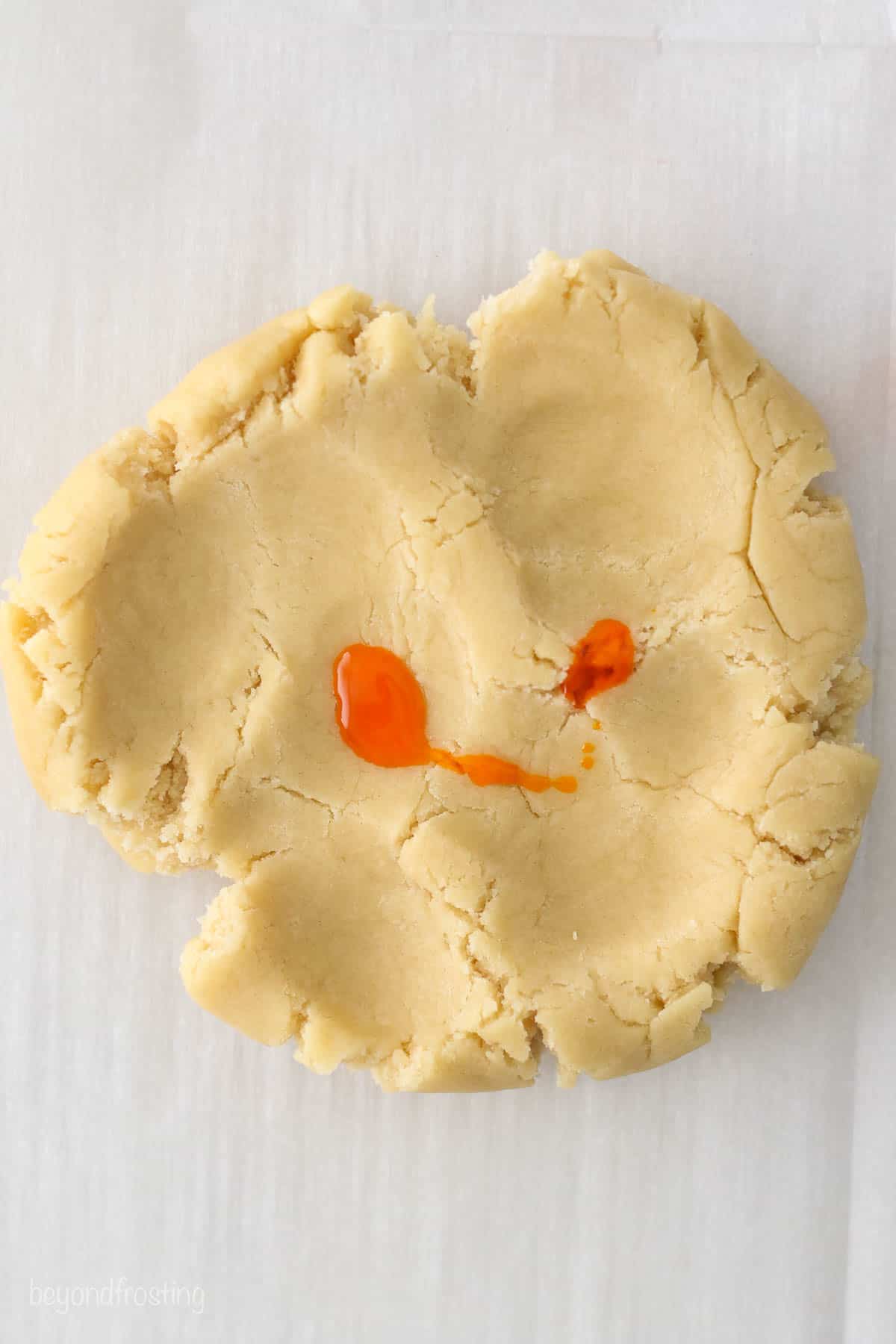Sugar cookie dough with a drop of orange food coloring