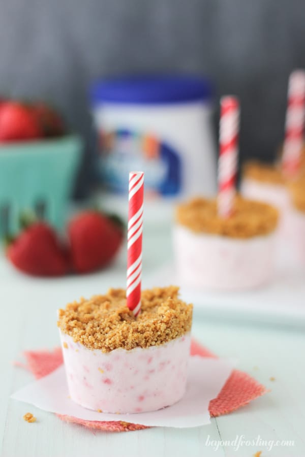 a strawberry marshmallow popsicle set upside down on a napkin