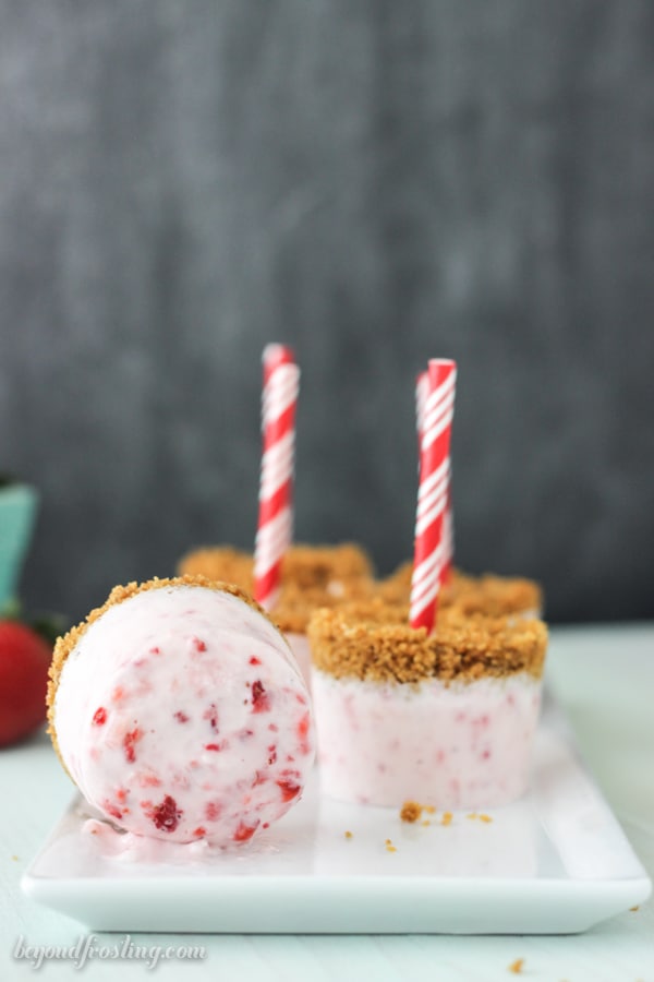 strawberry marshmallow popsicles lined on a plate side view
