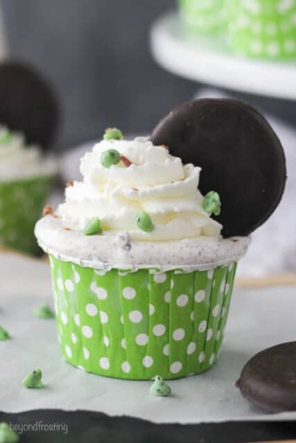 closeup of a thin mint ice cream cupcake in a green wrapper with white spots