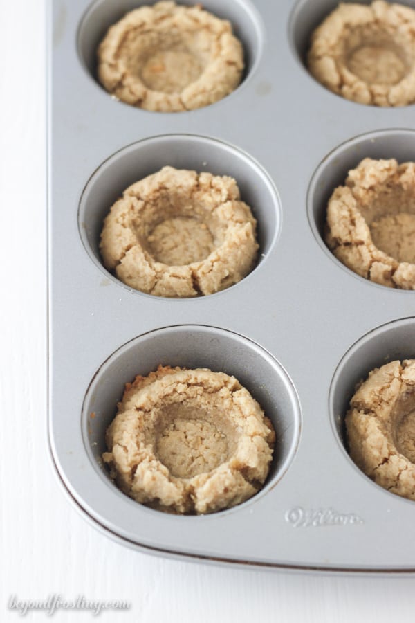 A wilton mini cupcake pan with cookies, pressed in the center