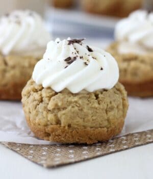 A decorated cookie cup on a piece of burlap