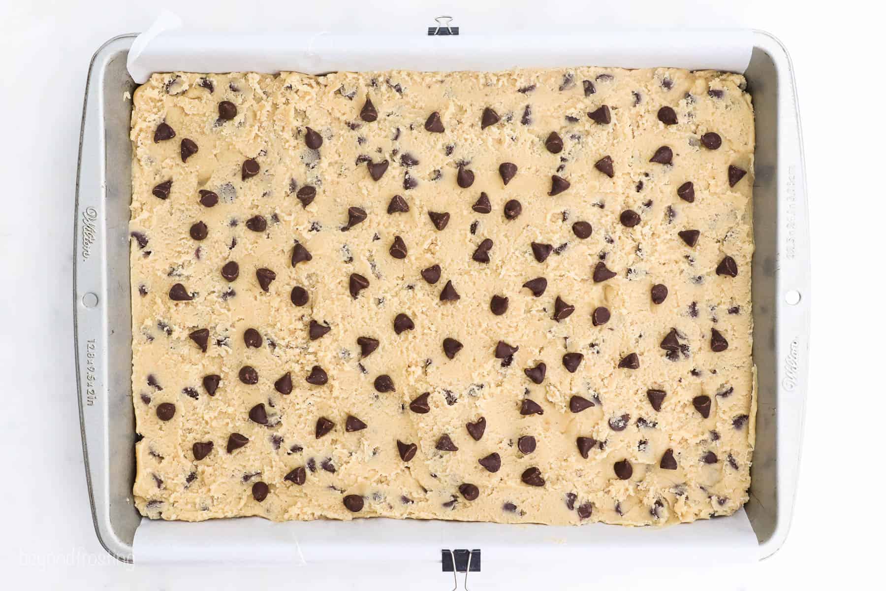 Cookie dough pressed into a baking pan