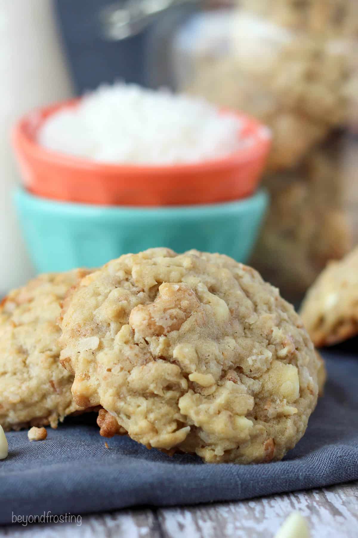 closeup of a coconut cashew oatmeal cookie leaning on another