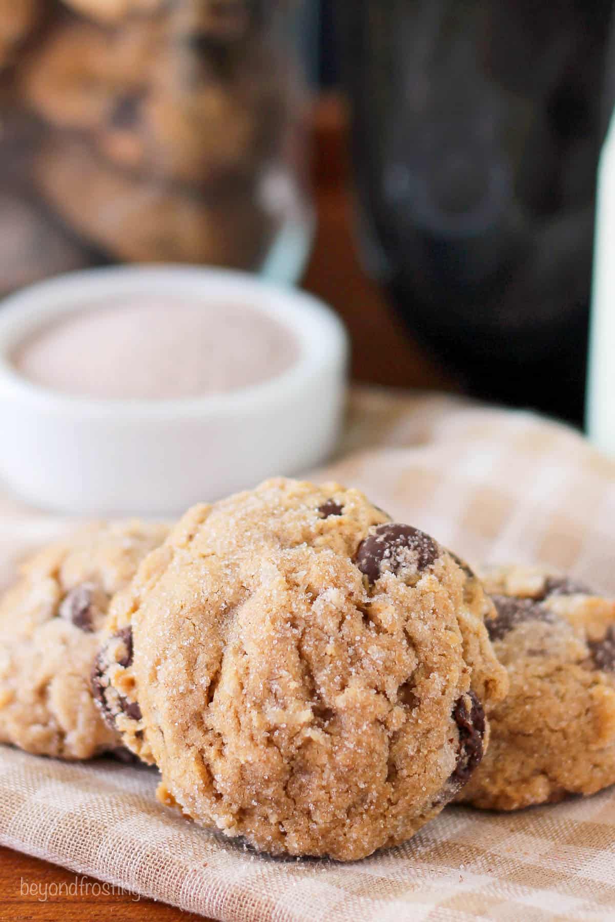 side view of a coconut chai chocolate chip cookie leaning on two other cookies