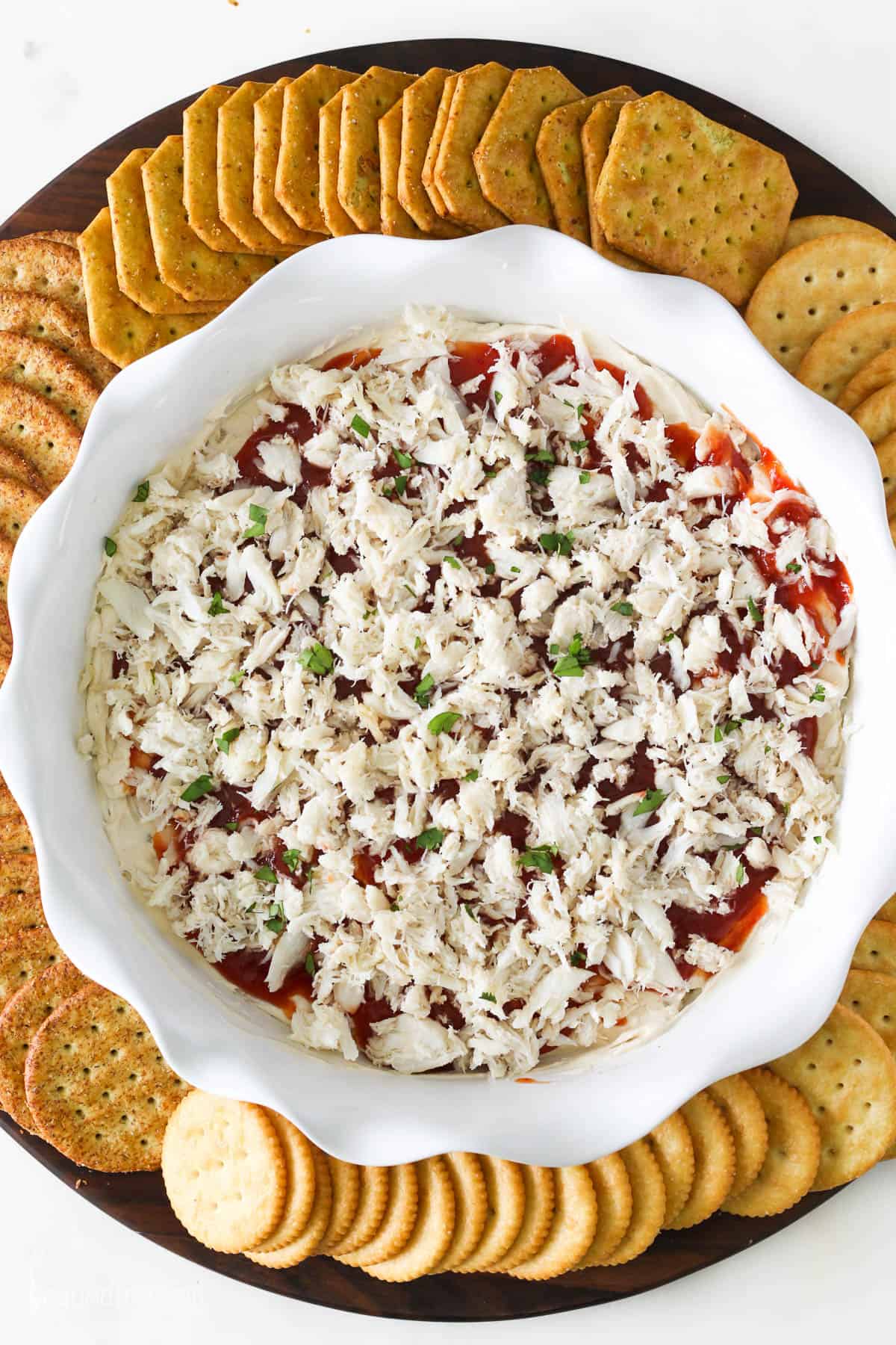 Overhead view of cold crab dip surrounded by crackers