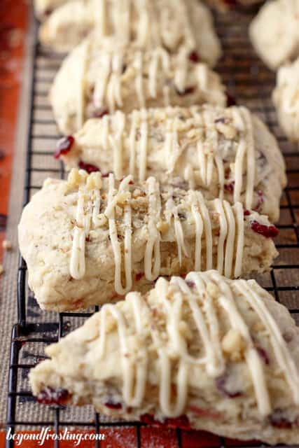 cranberry maple walnut scones lined up on a cooling rack