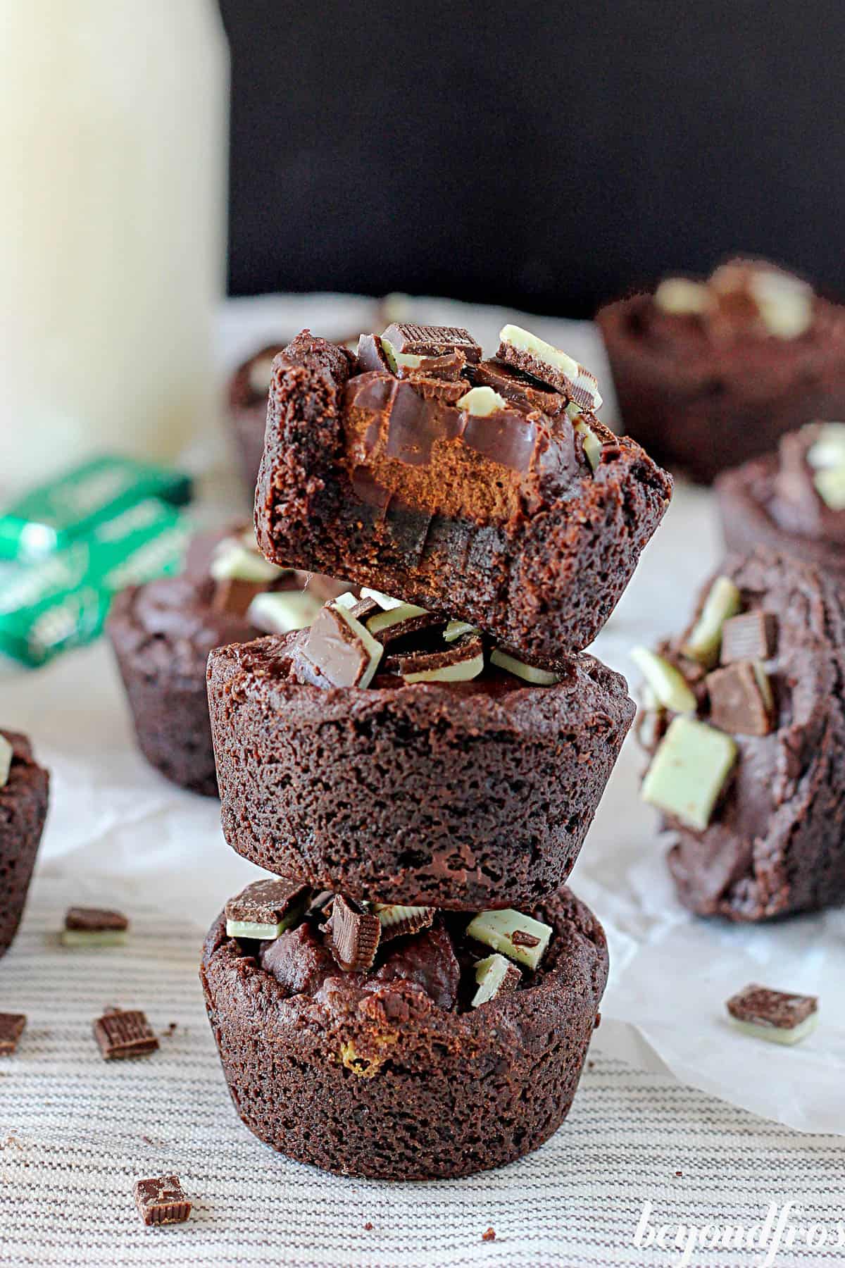 three chocolate mint cookie cups, one with a bite taken out