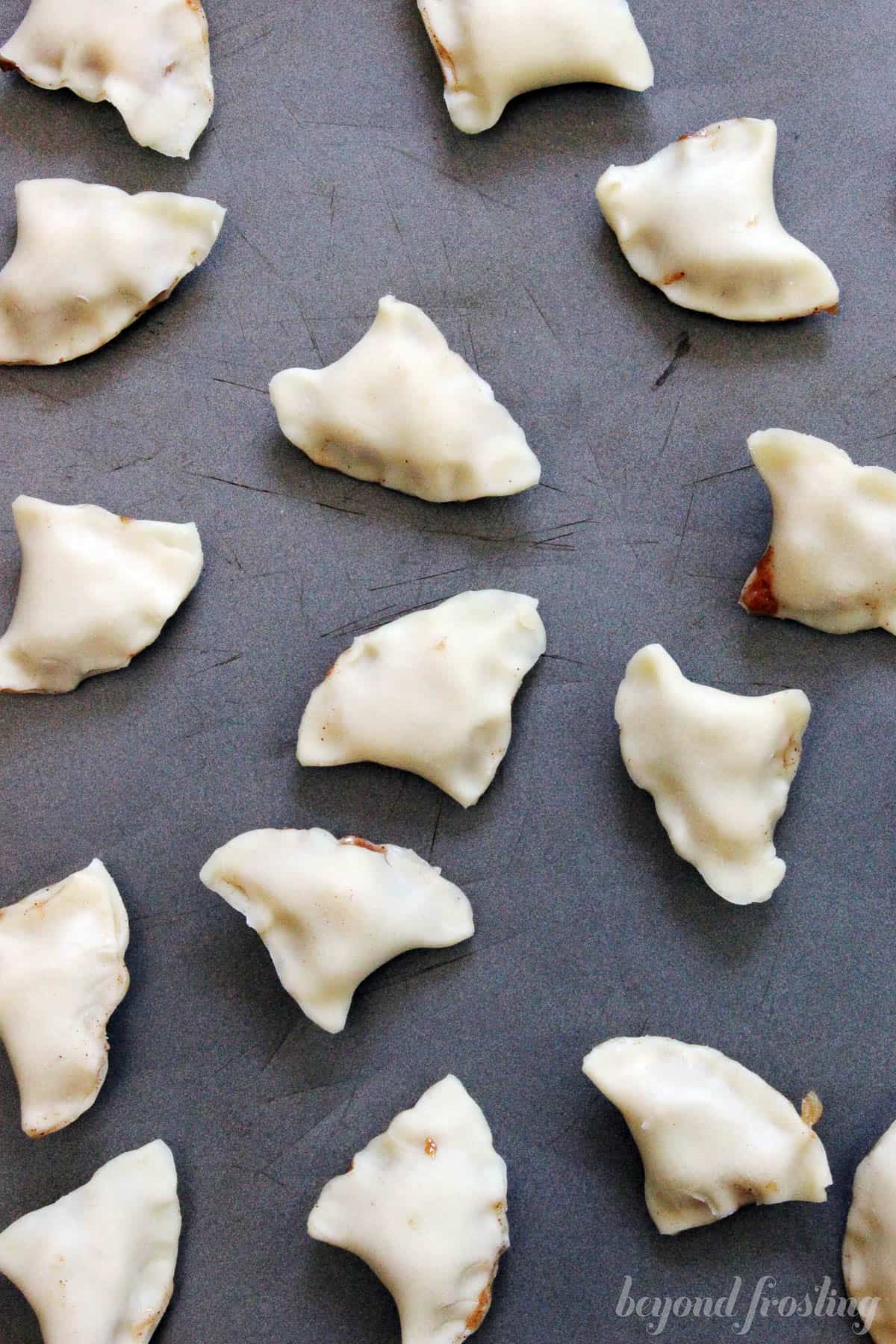 overhead shot of prepped apple pie bites on a baking sheet