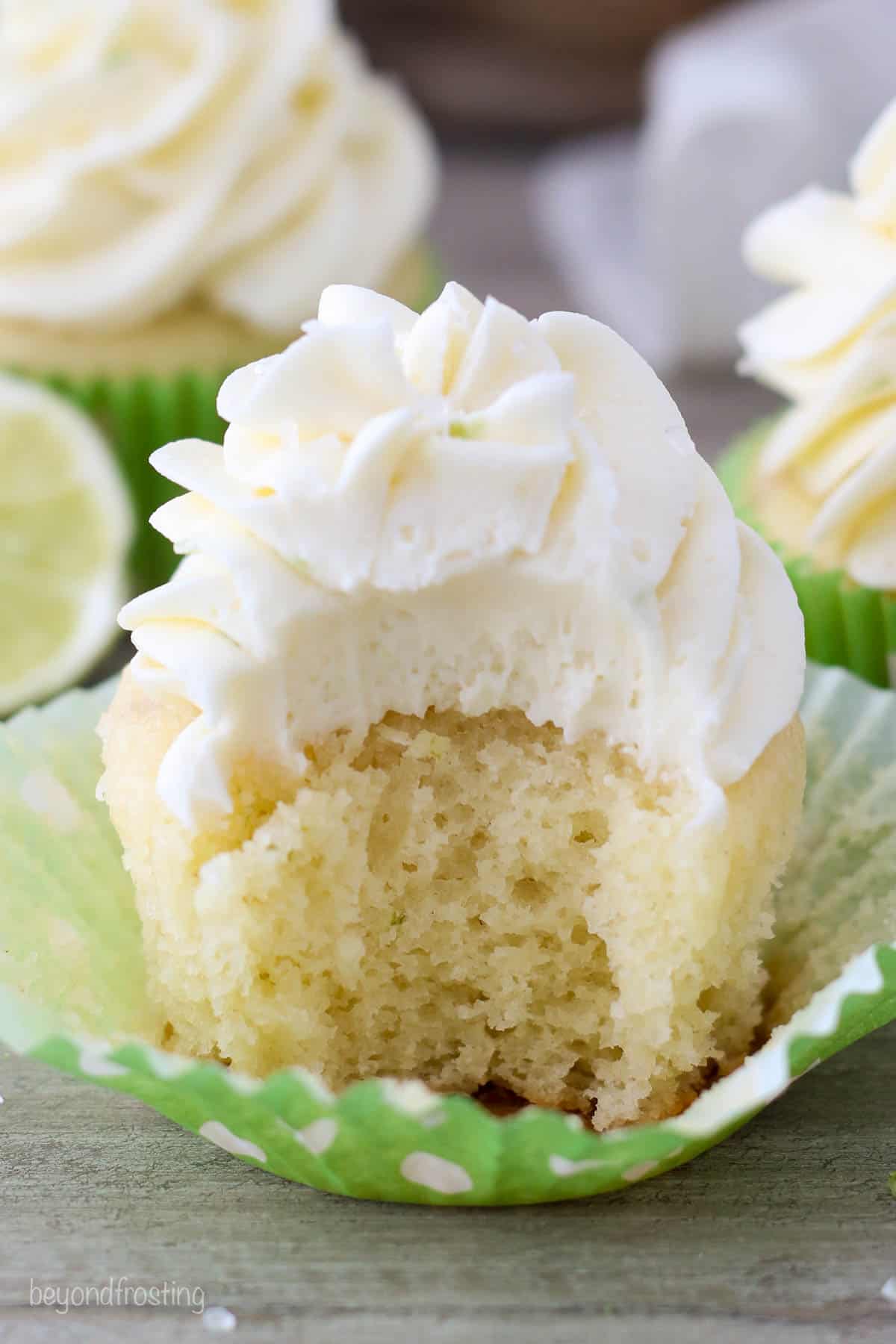 A vanilla cupcake with a bite missing