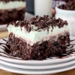 closeup of a slice of chocolate poke cake on a plate