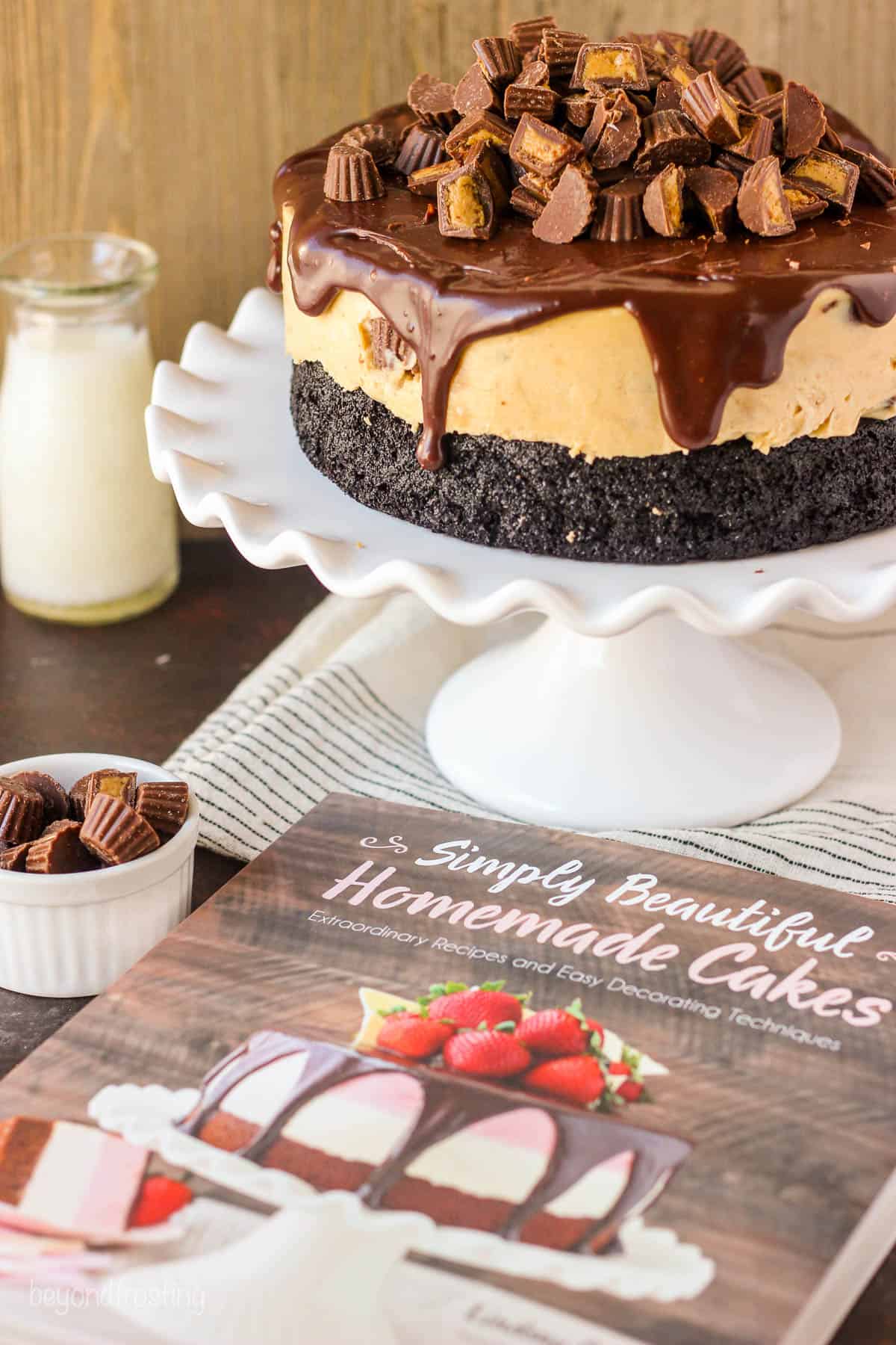 a cookbook lying next to a cake stand