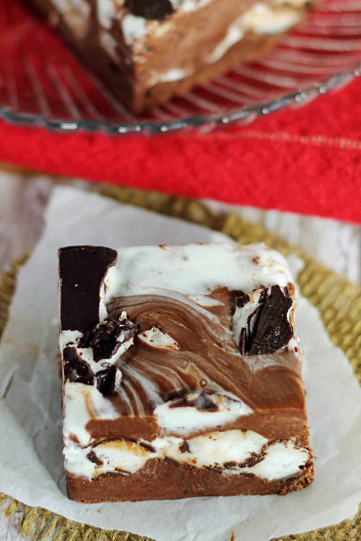overhead of a piece of peppermint patty fudge on a piece of parchment paper