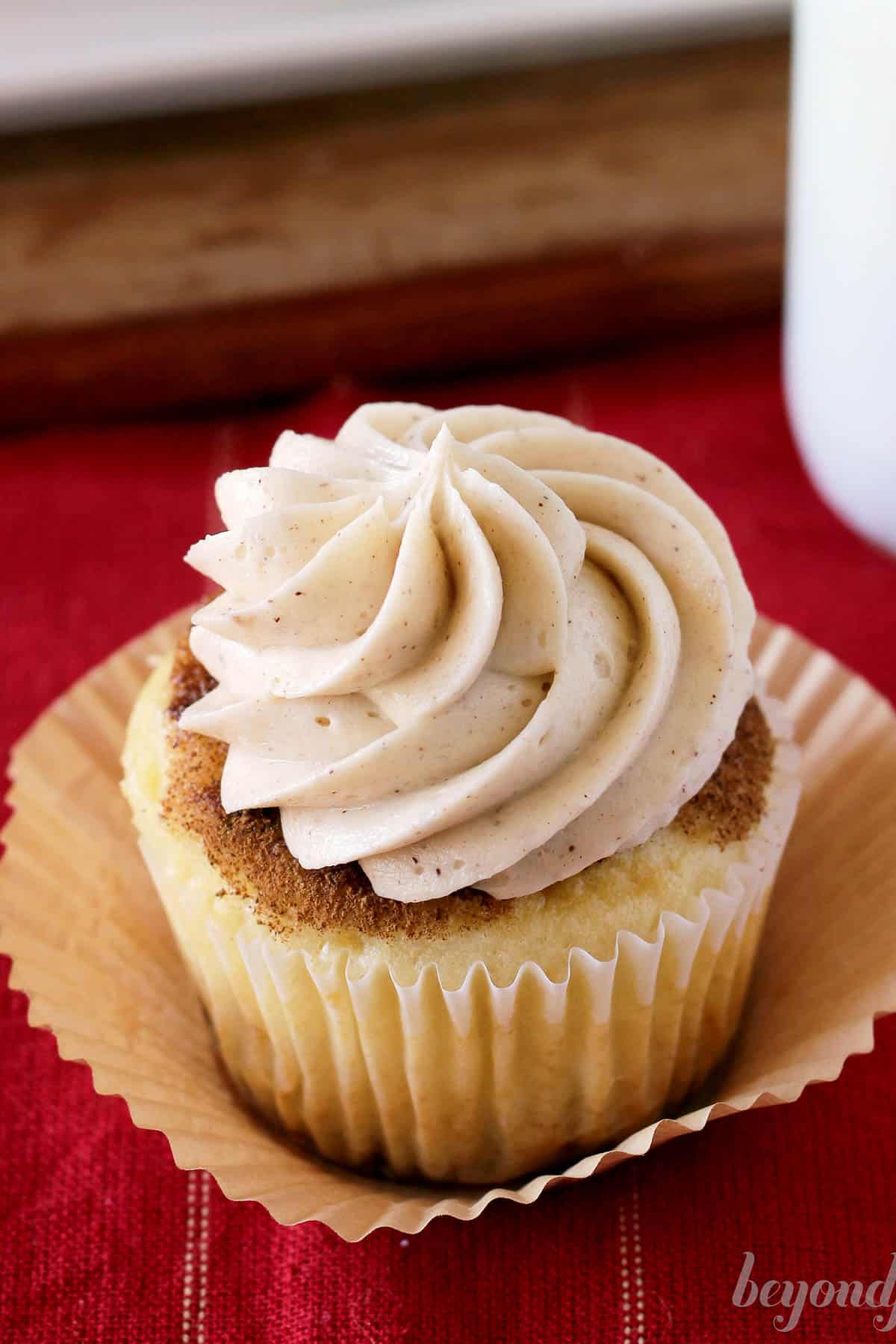 overhead of a frosted cupcake sitting in a cupcake liner