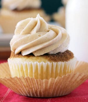 closeup of a frosted snickerdoodle cupcake sitting in a cupcake liner