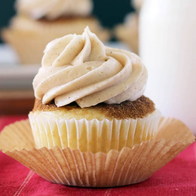closeup of a frosted snickerdoodle cupcake sitting in a cupcake liner
