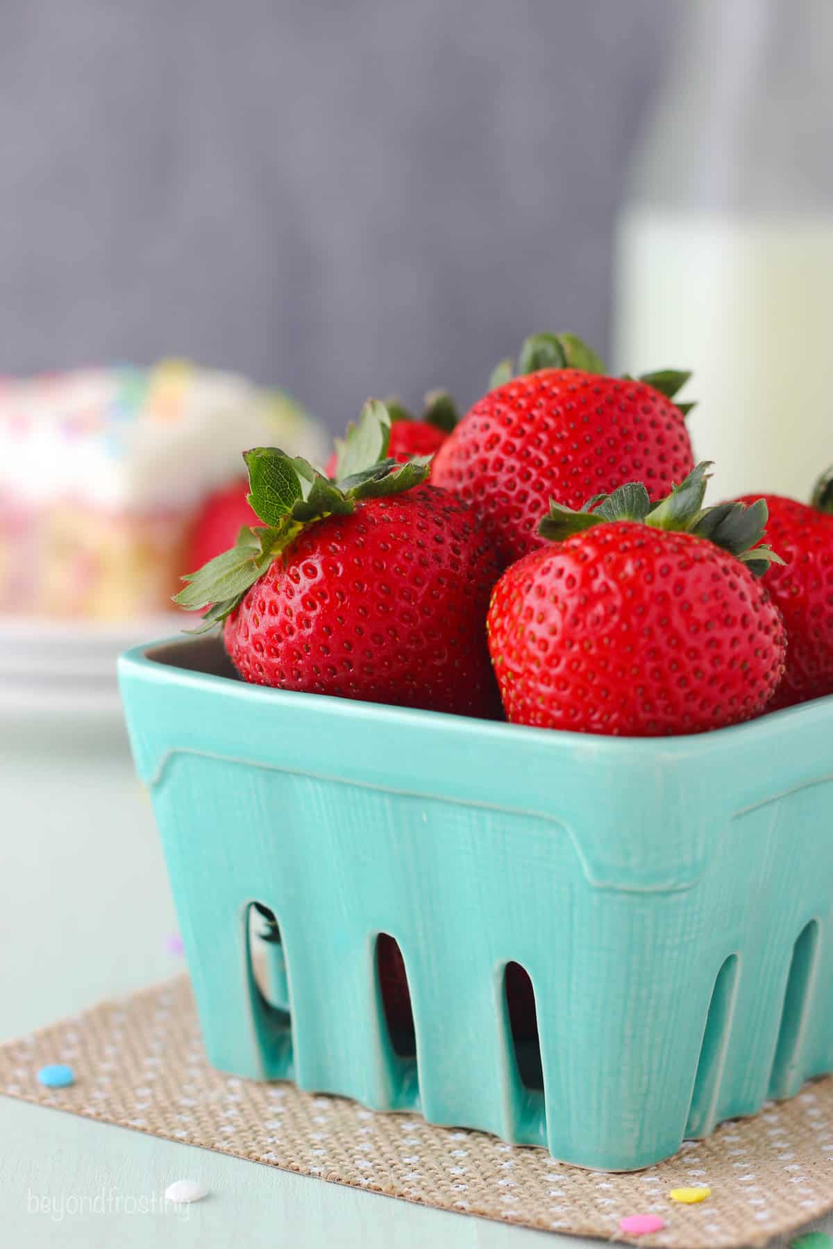 a carton of strawberries from the side
